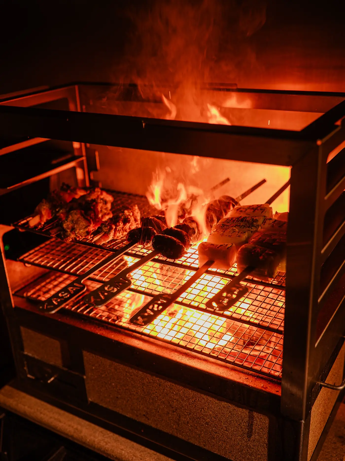 Meat over the open fire of the grill