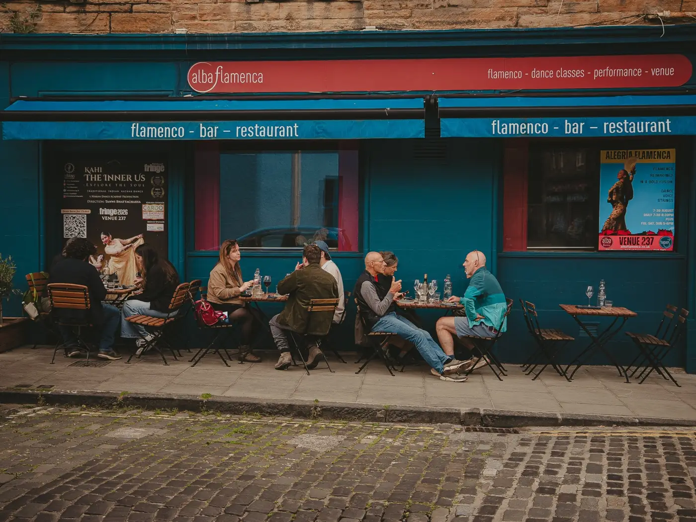 The blue frontage of tapastres on Howden Street, with people at the outside tables