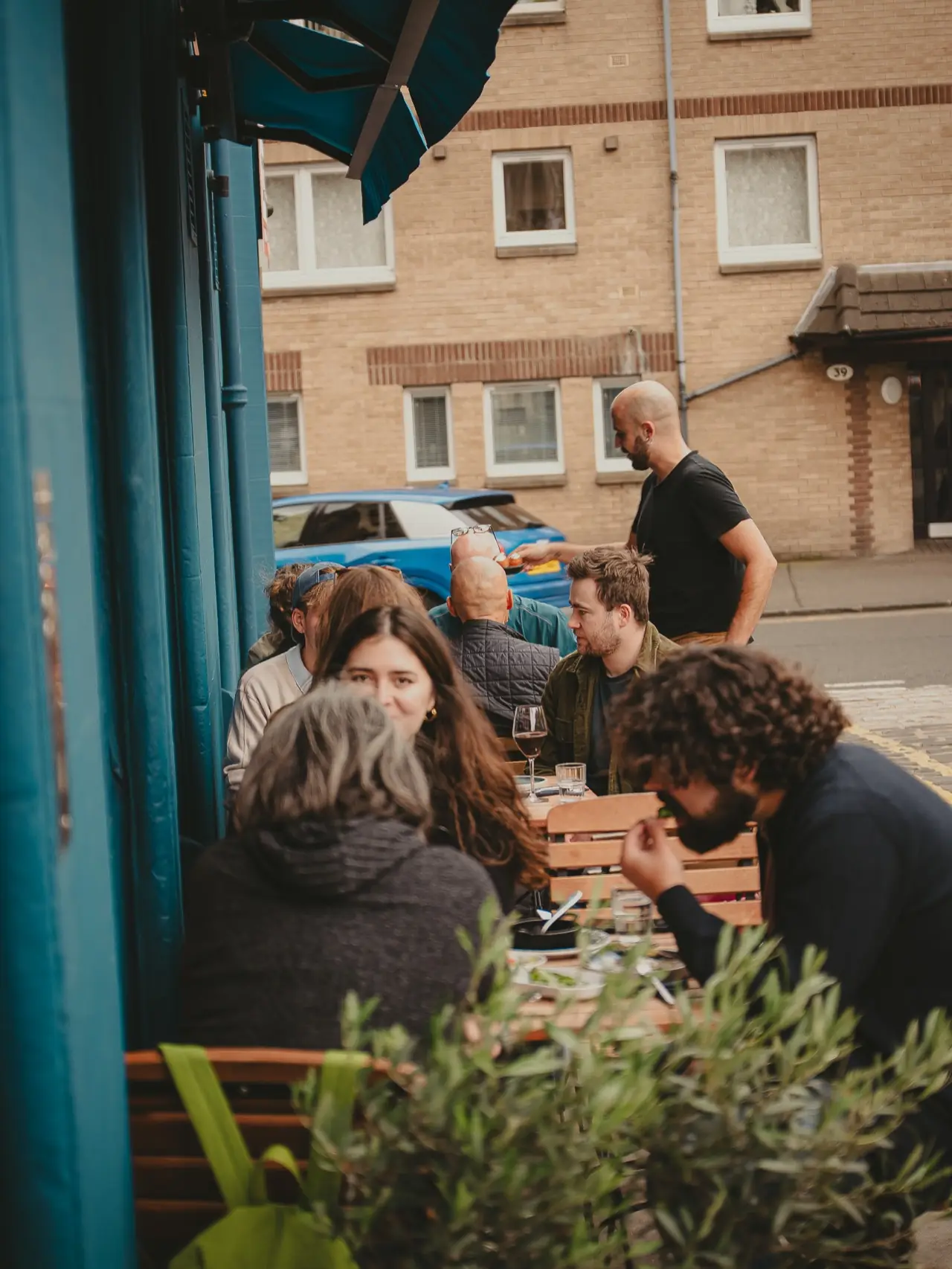 Guests eating outside on Howden Street in the late afternoon